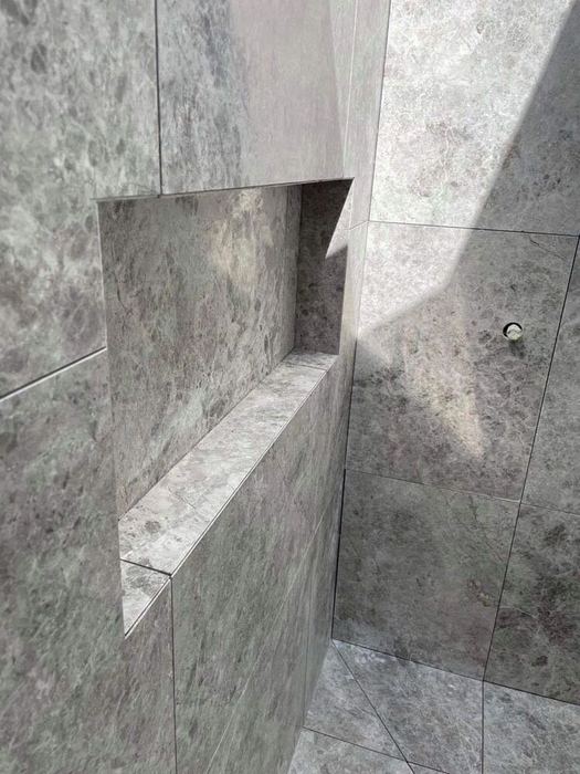 Macro of a mitred marble niche shelf edge with dramatic side lighting