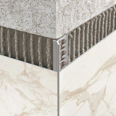 Close-up of a clean mitred corner joint between two stone finishes