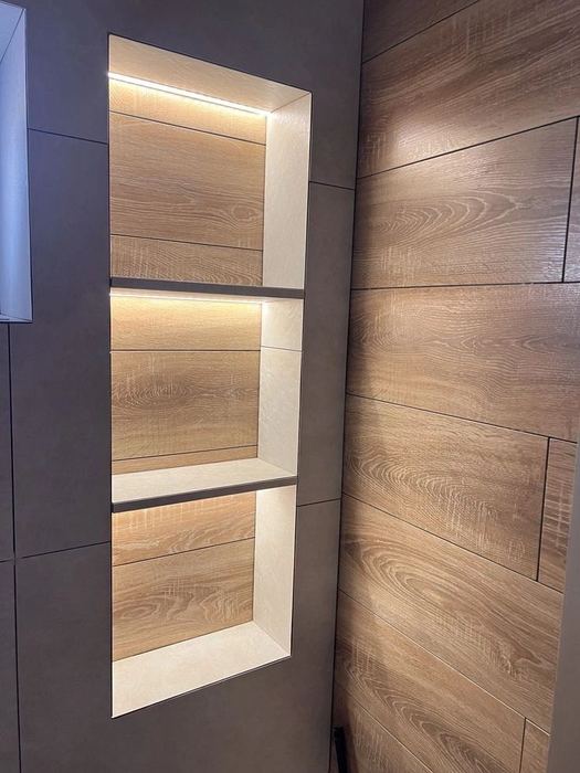 Three-tier backlit LED niche in wood-look tile