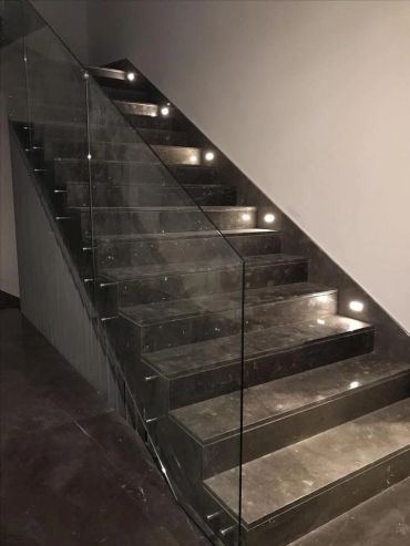 Open staircase with glass balustrade and embedded tread lighting
